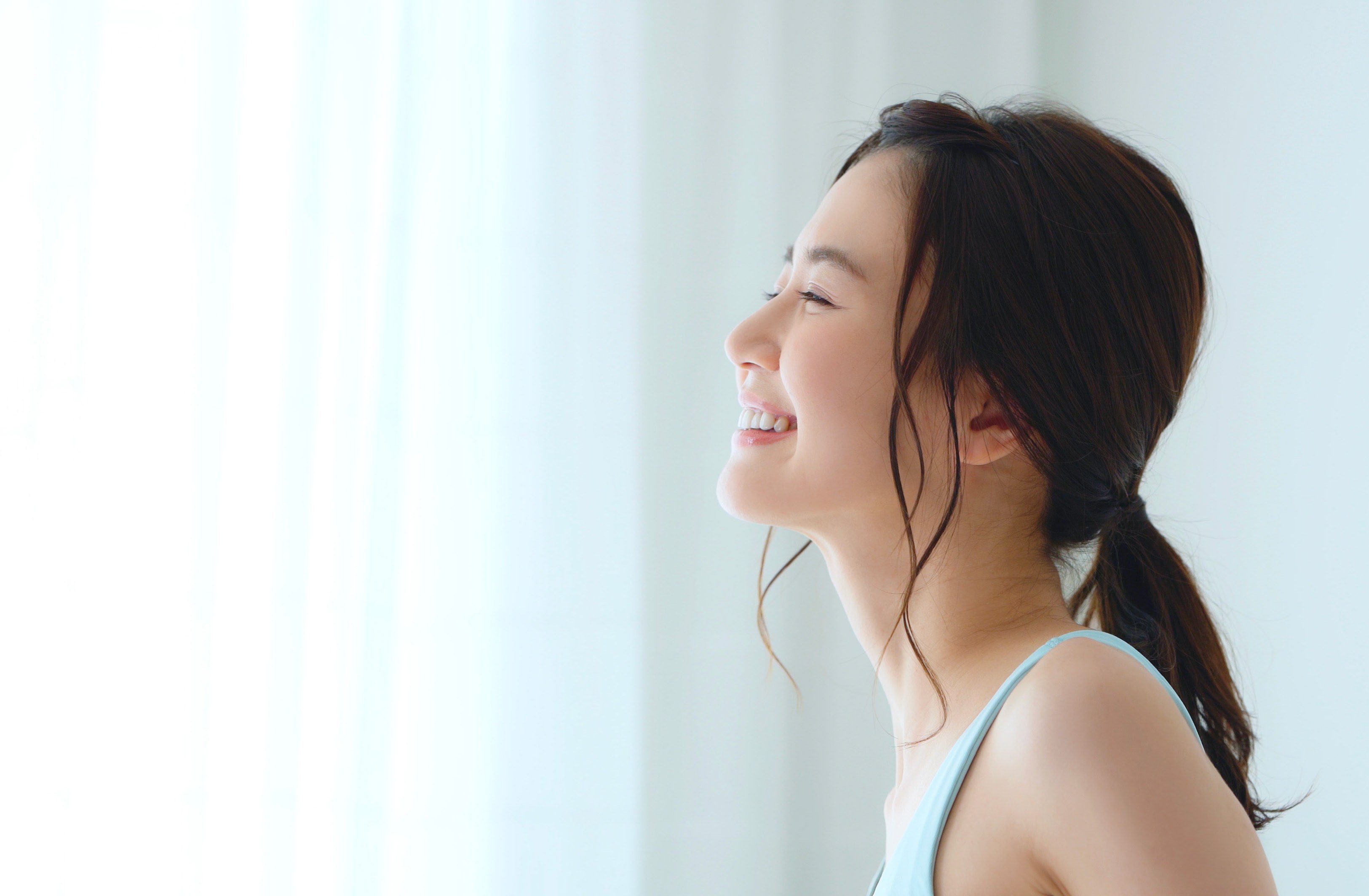 Woman smiling by the window at Serensia Woods