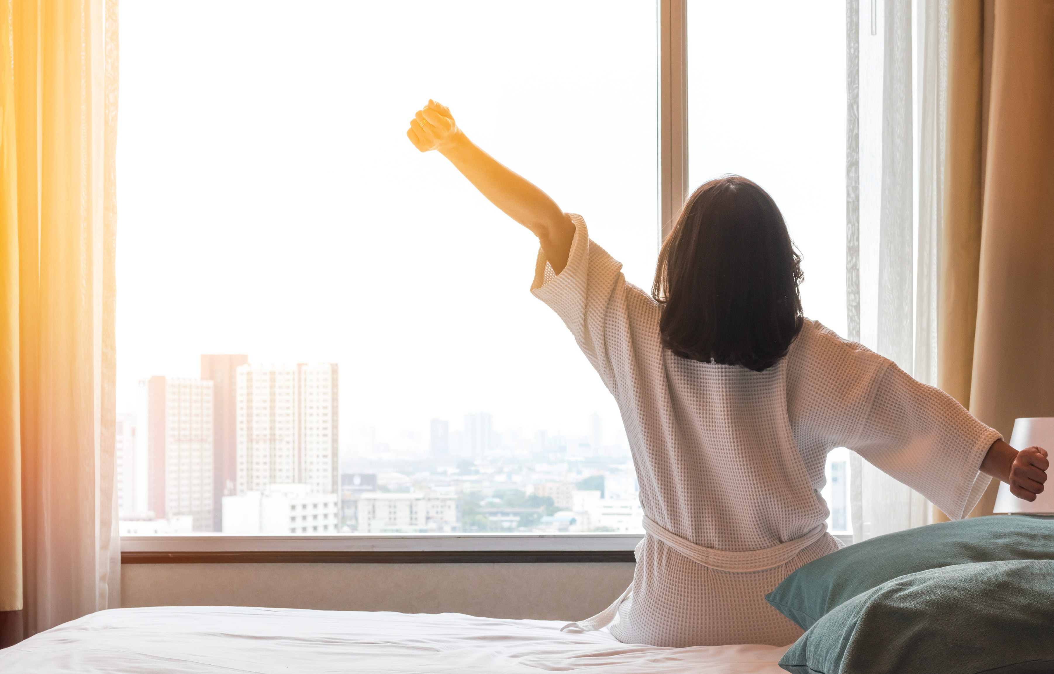 Guest stretching by the window at Serensia Woods